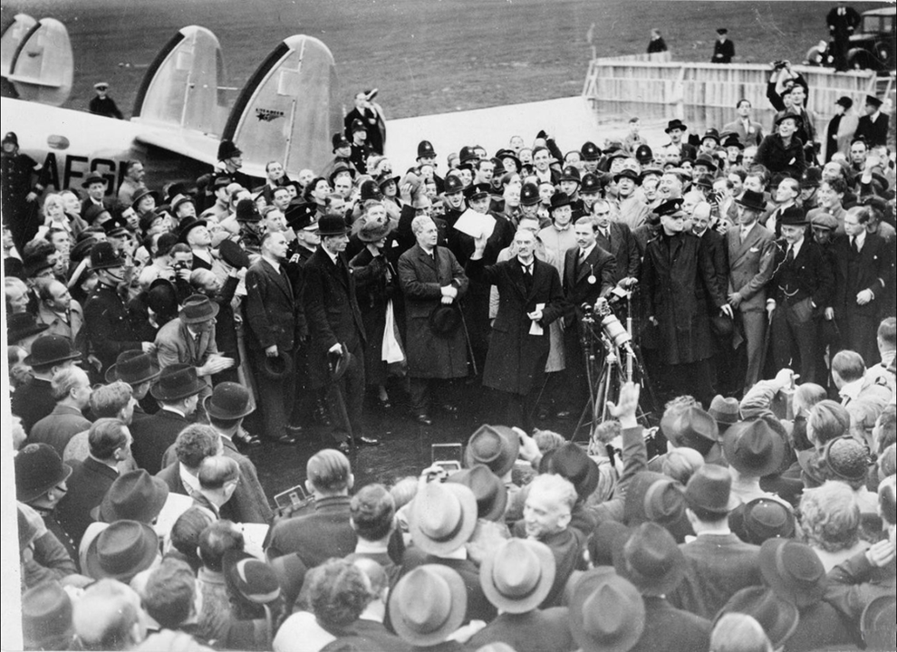 Le 30 septembre 1938, le Premier ministre britannique Neville Chamberlain brandit à la foule le traité de Munich. D.R.